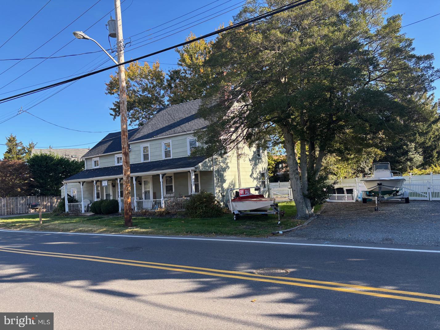 70 Main Street Waretown, NJ 08758 - Photo 10 of 54 a front view of a house with a garden and trees