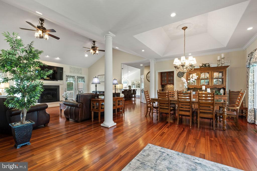 7609 Baileys Road Spotsylvania, VA 22551 - Photo 11 of 111 a view of a dining room and livingroom with furniture wooden floor a chandelier