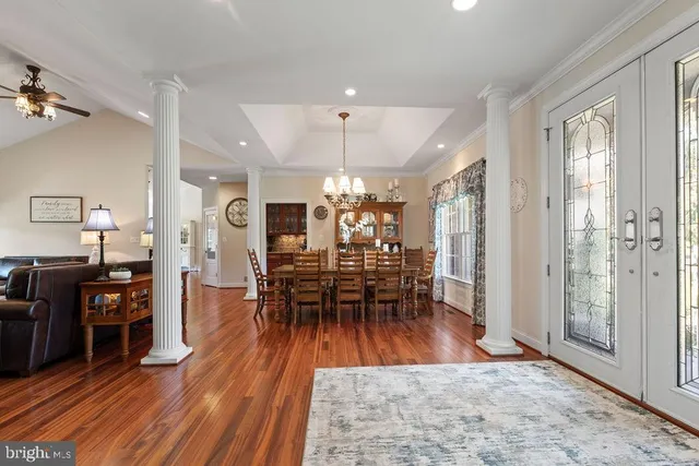 a kitchen with a refrigerator and wooden floor
