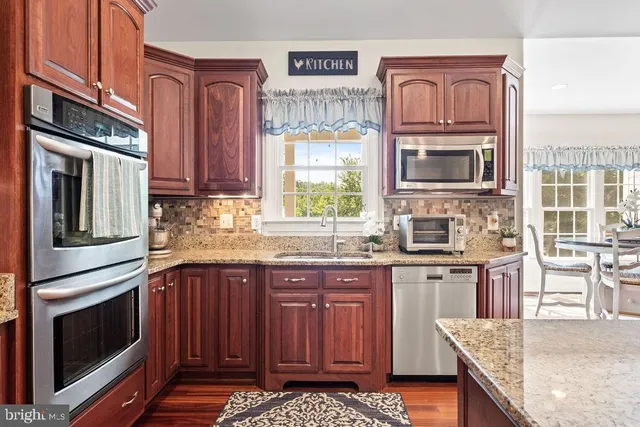 a living room with fireplace furniture and a large window