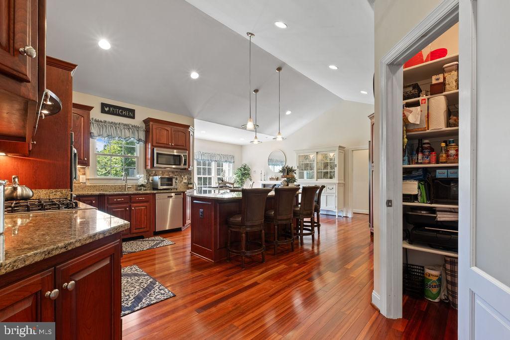 7609 Baileys Road Spotsylvania, VA 22551 - Photo 20 of 111 a kitchen with stainless steel appliances granite countertop a refrigerator a stove top oven a dining table and chairs