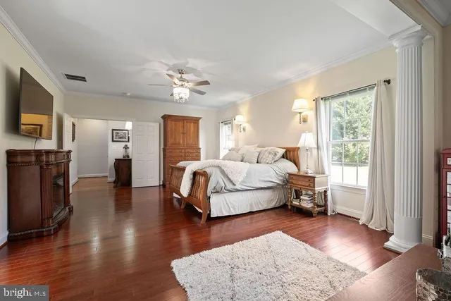a bedroom with furniture and a large window
