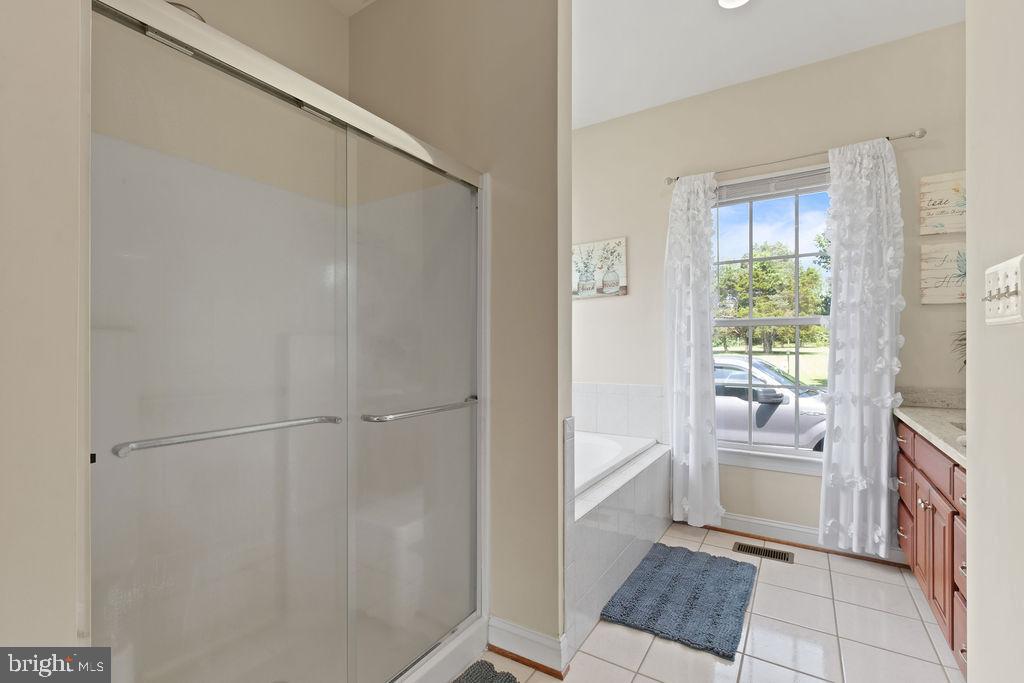 7609 Baileys Road Spotsylvania, VA 22551 - Photo 50 of 111 a bathroom with a tub shower and a sink