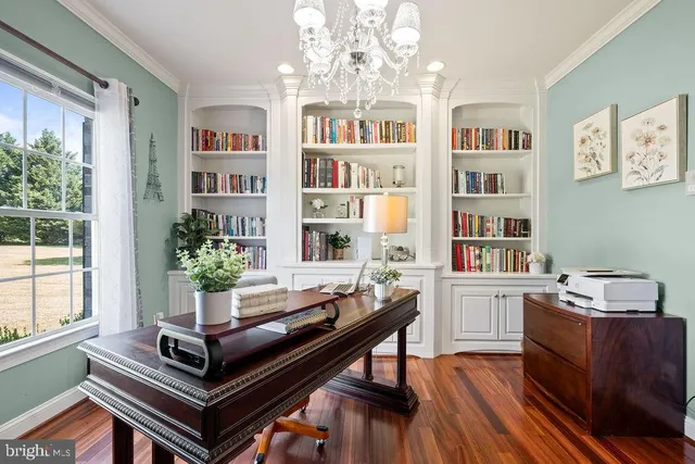 a view of a dining room with furniture a chandelier and wooden floor
