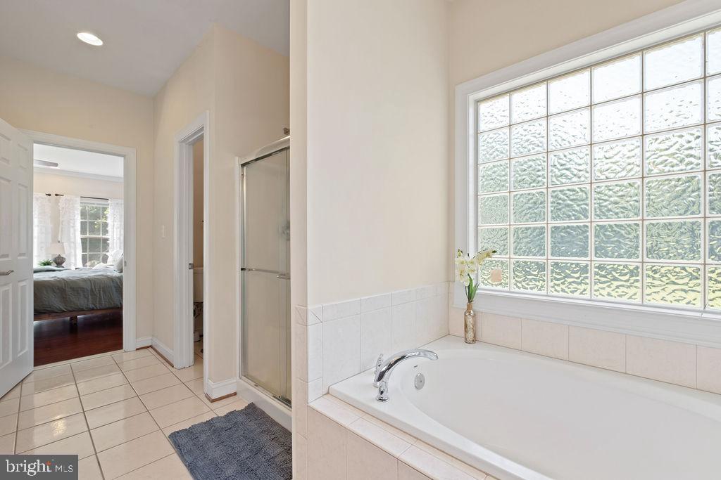 7609 Baileys Road Spotsylvania, VA 22551 - Photo 92 of 111 a bathroom with a bathtub and a shower