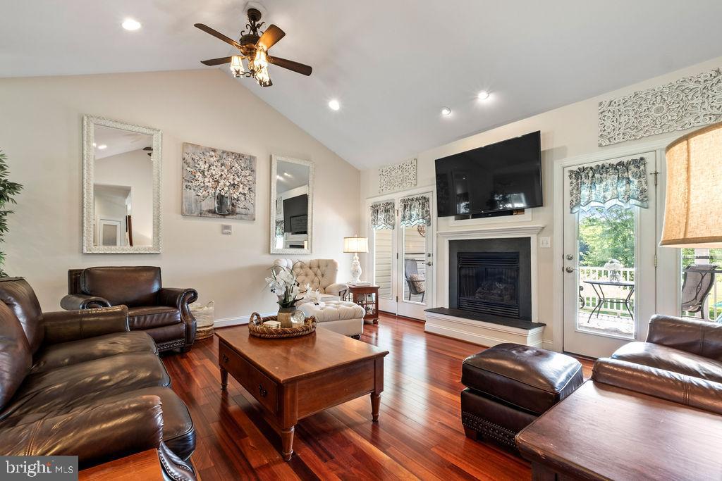 7609 Baileys Road Spotsylvania, VA 22551 - Photo 10 of 111 a living room with furniture a fireplace and a flat screen tv