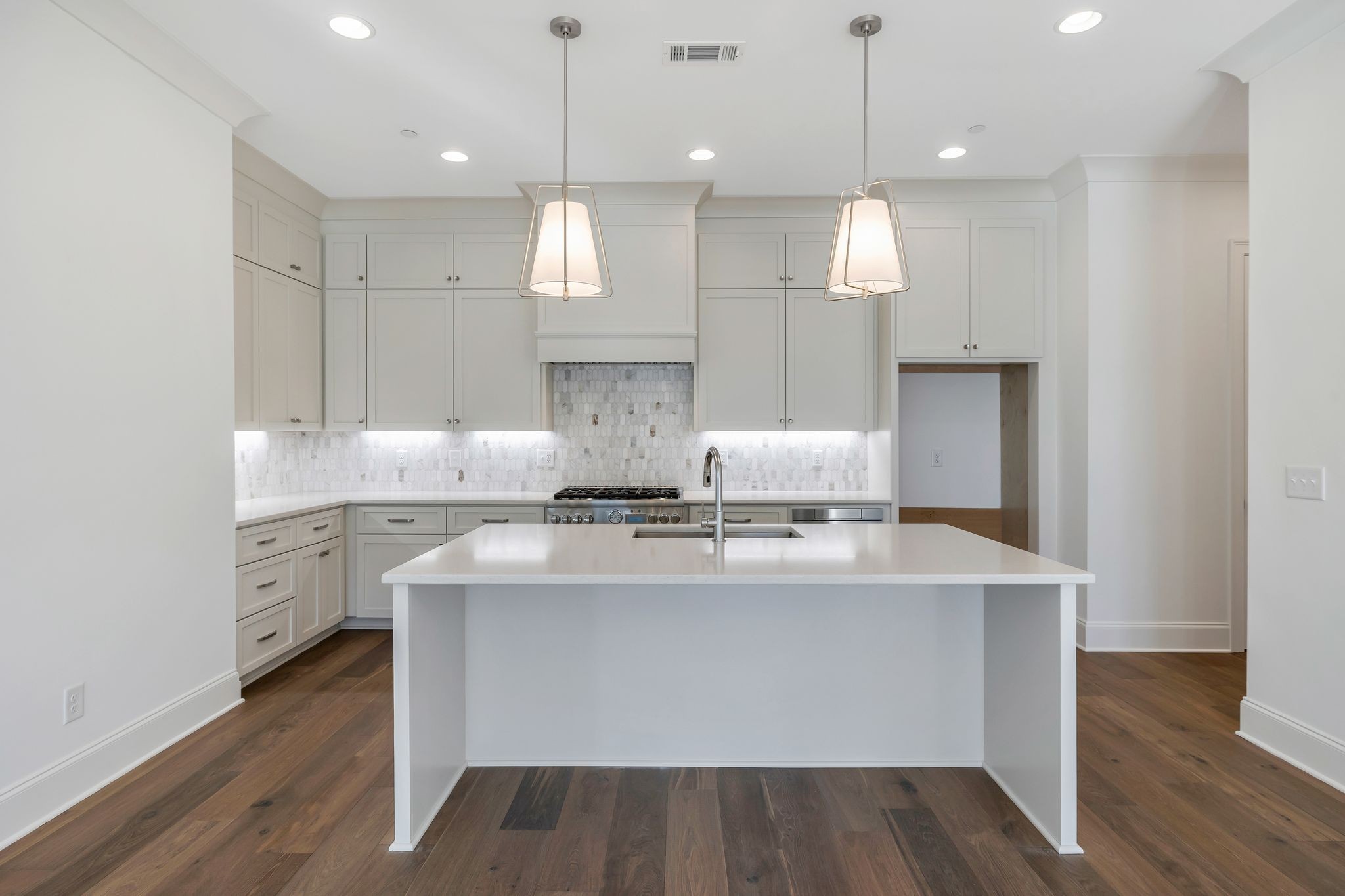 6037 Whitman Road, Unit 203 Franklin, TN 37064 - Photo 13 of 52 a kitchen with kitchen island white cabinets stainless steel appliances and a fireplace