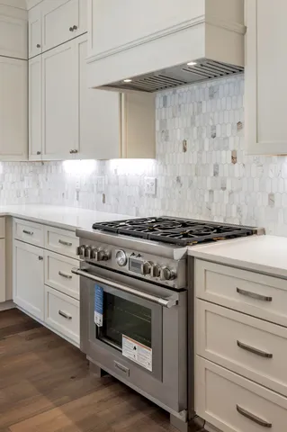 a stove top oven sitting inside of a kitchen