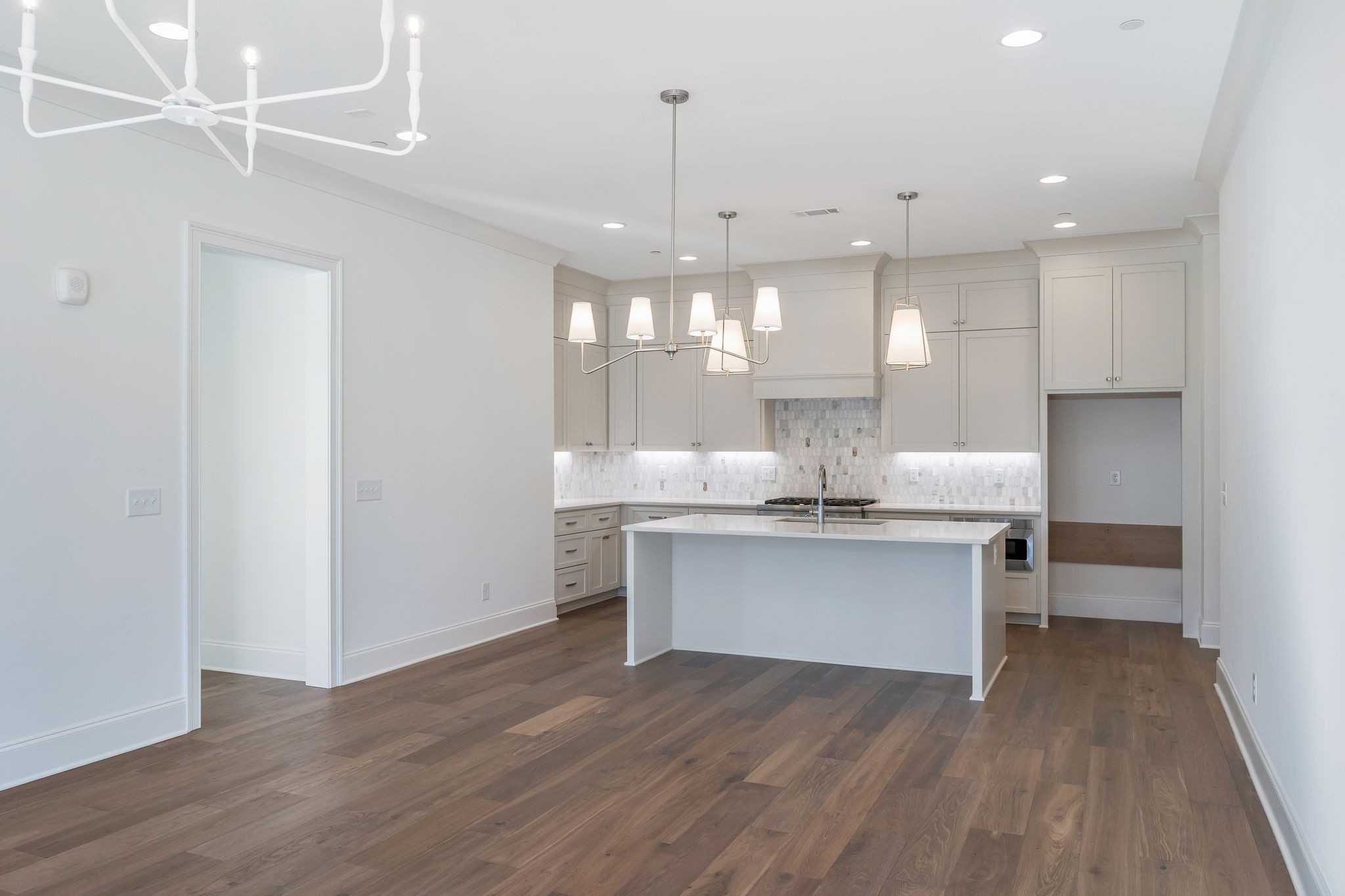 6037 Whitman Road, Unit 203 Franklin, TN 37064 - Photo 20 of 52 a kitchen with white cabinets stainless steel appliances and a chandelier