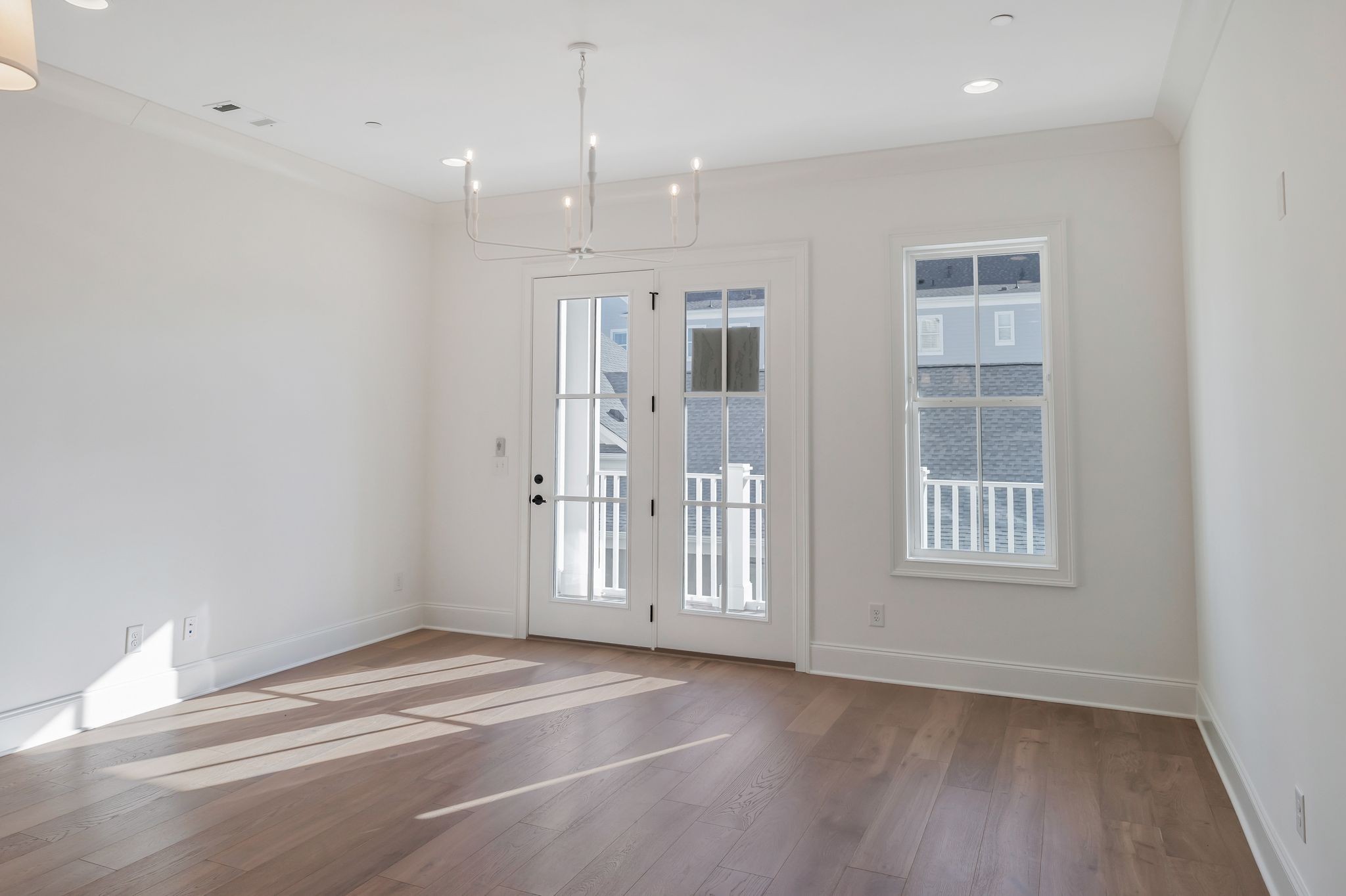 6037 Whitman Road, Unit 203 Franklin, TN 37064 - Photo 22 of 52 a view of an empty room with wooden floor and windows