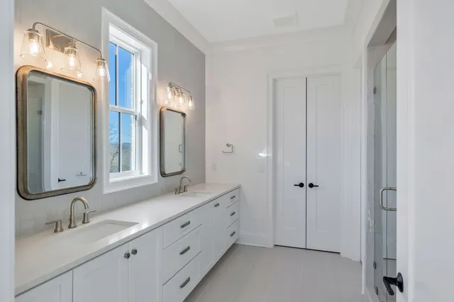 a bathroom with a double vanity sink mirror and