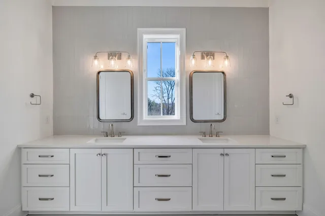 a bathroom with a double vanity sink and a mirror