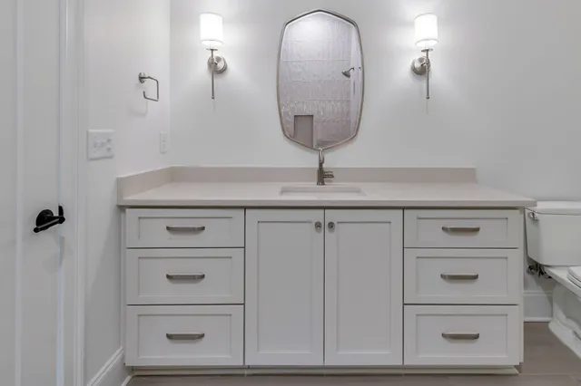 a room with cabinets and a mirror