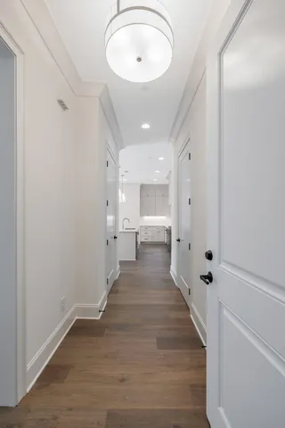 a view of a hallway with wooden floor