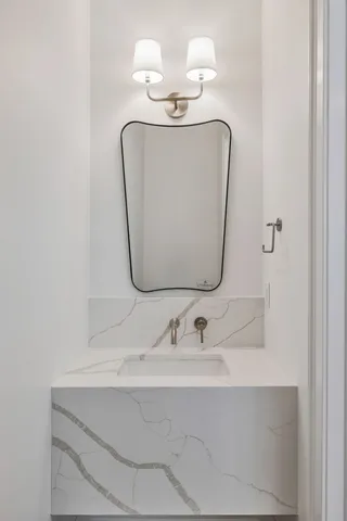 a bathroom with a sink mirror and vanity