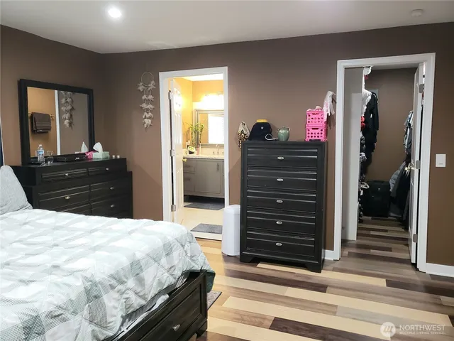 a bed room with a bed and a dresser