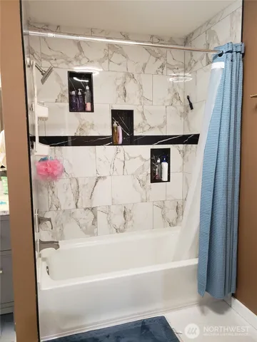 a bathroom with a bathtub and a shower