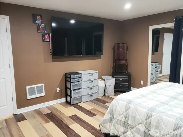 a bedroom with a bed and dresser