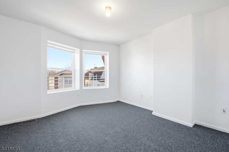 44 3rd Street Newark, NJ 07107 - Photo 4 of 12 an empty room with windows