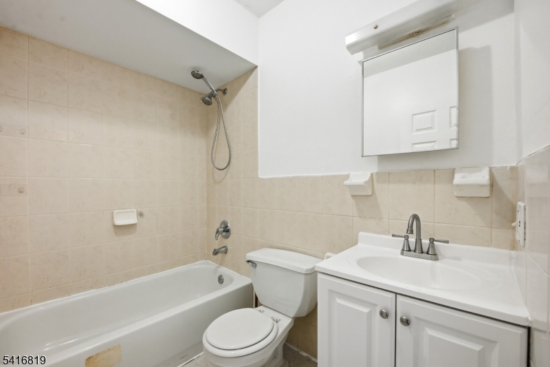 44 3rd Street Newark, NJ 07107 - Photo 9 of 12 a bathroom with a sink a toilet and bathtub