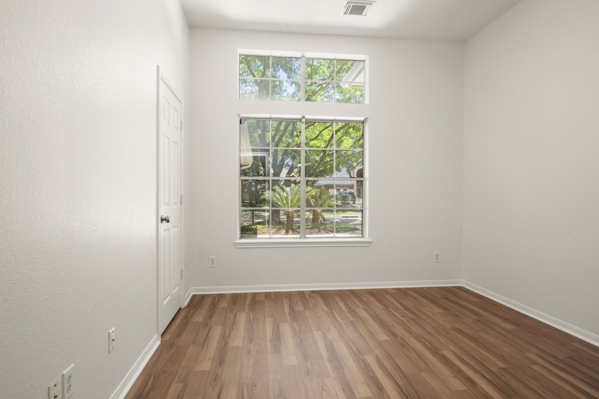 2018 Copperwood Park Lane Spring, TX 77386 - Photo 11 of 33 an empty room with wooden floor and windows