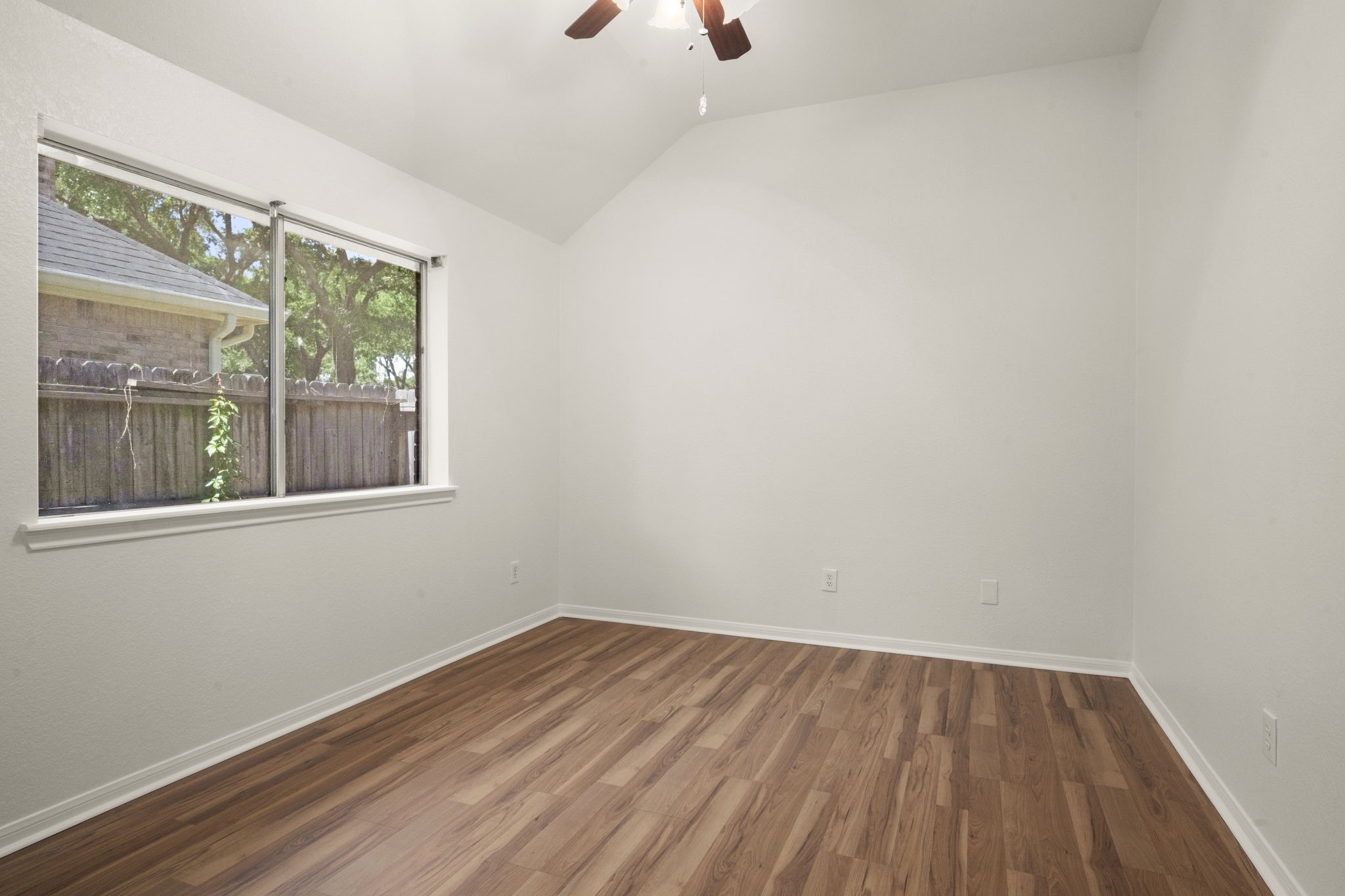 2018 Copperwood Park Lane Spring, TX 77386 - Photo 13 of 33 a view of an empty room with wooden floor and a window