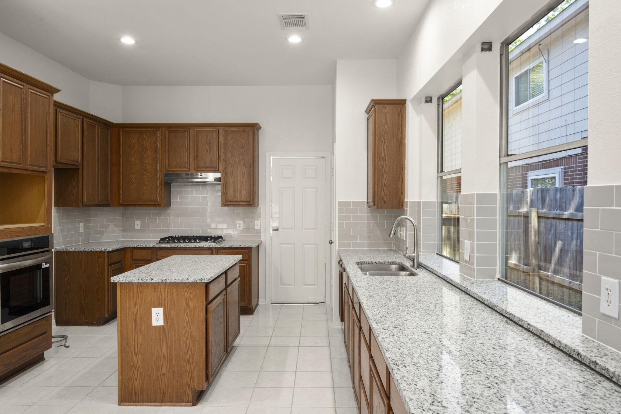 2018 Copperwood Park Lane Spring, TX 77386 - Photo 15 of 33 a large kitchen with stainless steel appliances granite countertop a stove a sink and a refrigerator