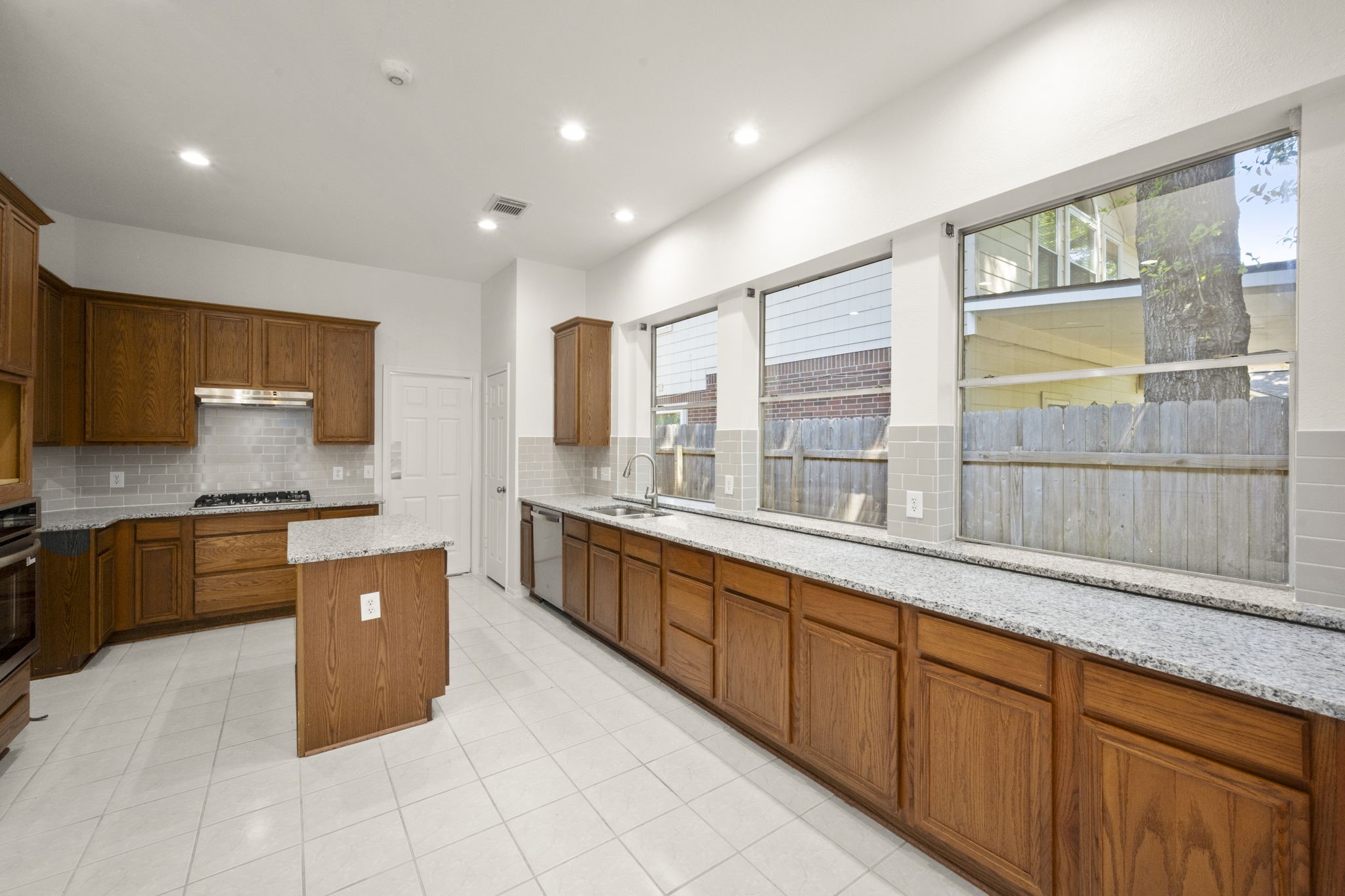 2018 Copperwood Park Lane Spring, TX 77386 - Photo 16 of 33 a large kitchen with stainless steel appliances granite countertop a large counter top a stove a sink and a refrigerator