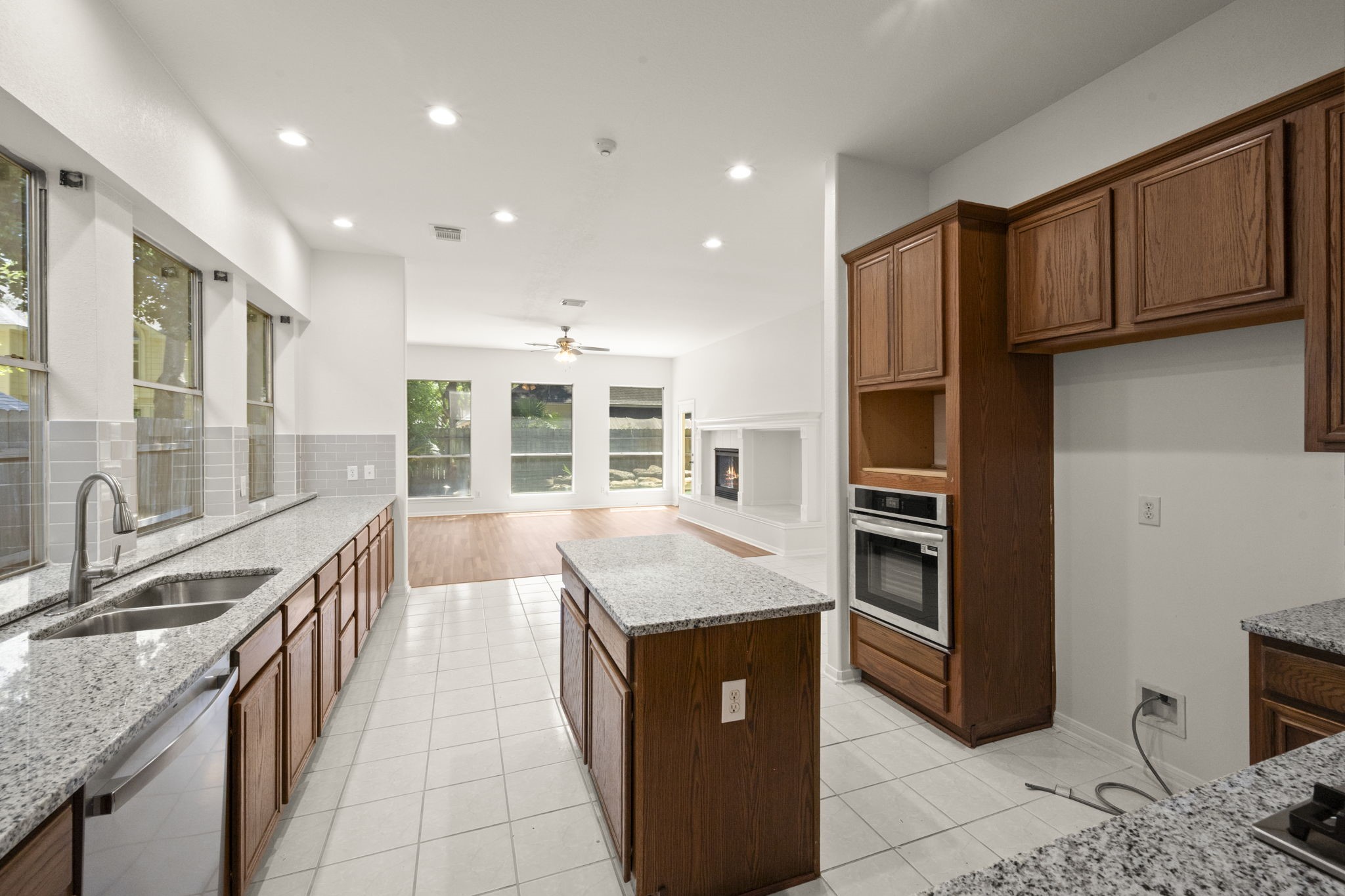 2018 Copperwood Park Lane Spring, TX 77386 - Photo 17 of 33 a large kitchen with kitchen island granite countertop a large window and a sink