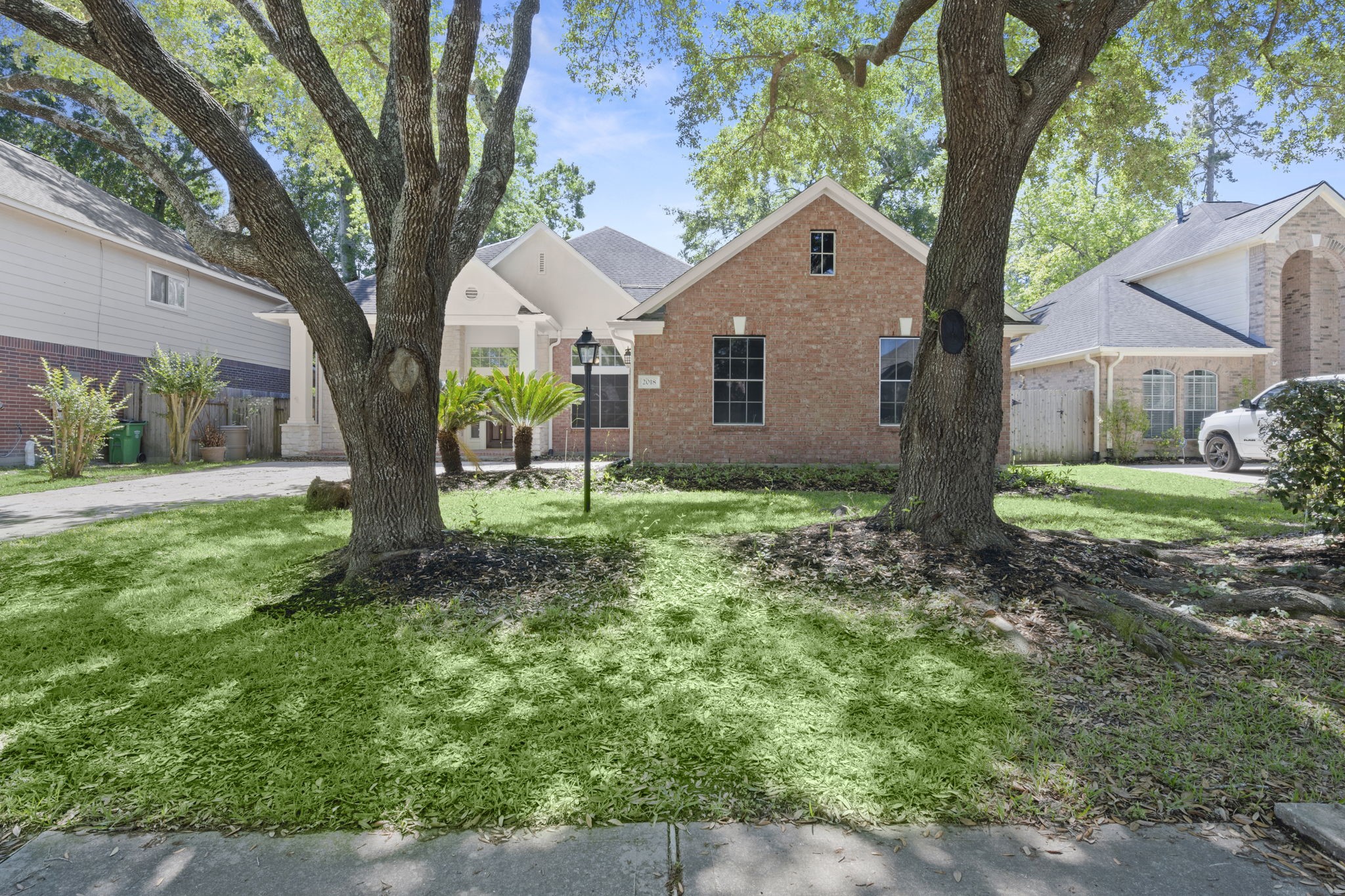 2018 Copperwood Park Lane Spring, TX 77386 - Photo 2 of 33 a front view of house with yard and green space