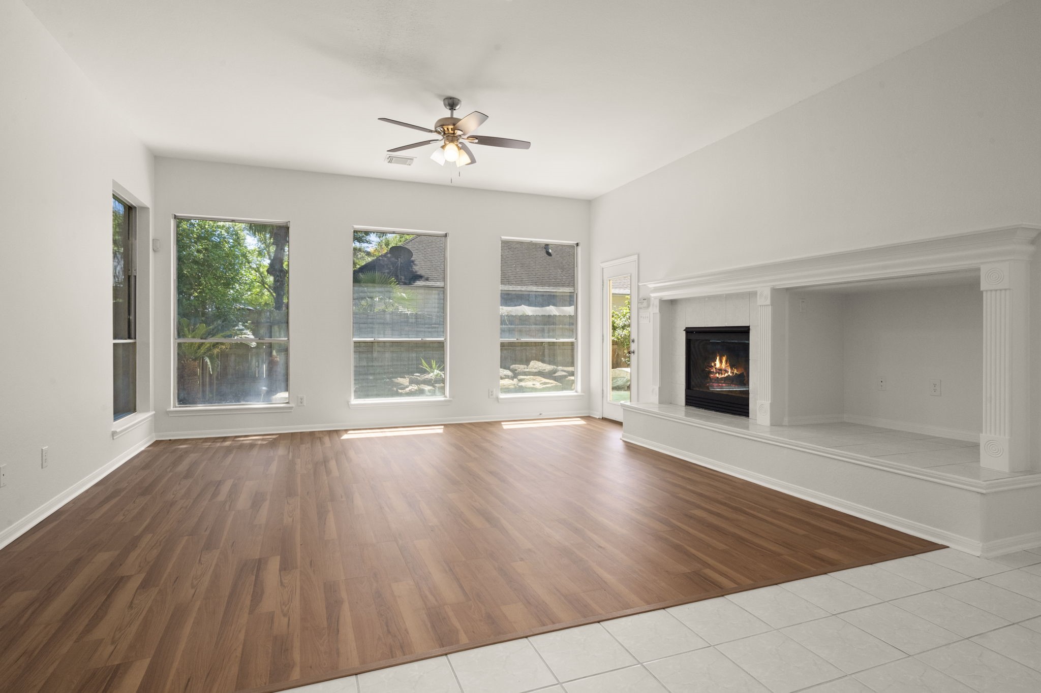 2018 Copperwood Park Lane Spring, TX 77386 - Photo 21 of 33 a view of an empty room with wooden floor and a window