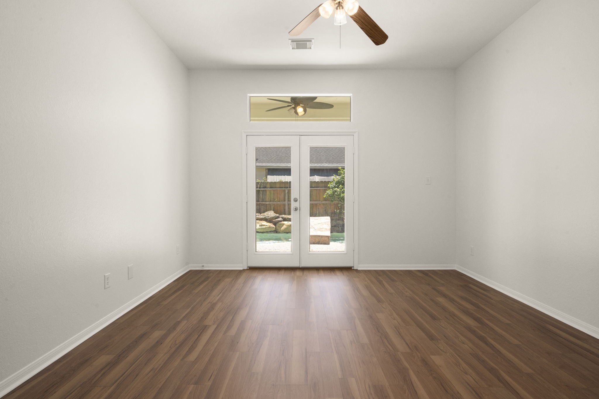 2018 Copperwood Park Lane Spring, TX 77386 - Photo 24 of 33 an empty room with wooden floor and windows