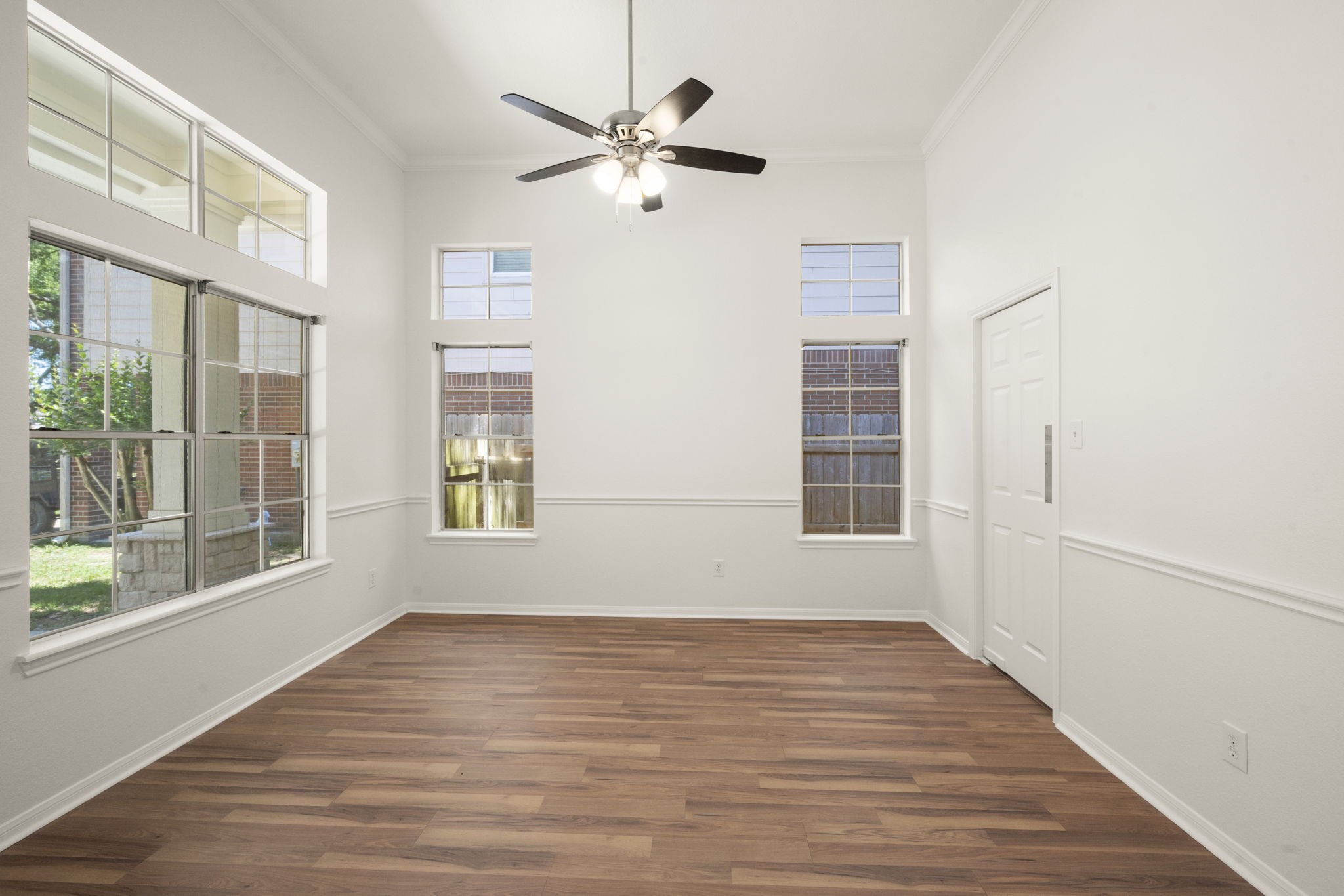 2018 Copperwood Park Lane Spring, TX 77386 - Photo 10 of 33 a view of an empty room with wooden floor and a window