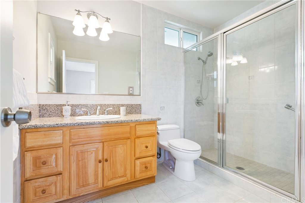 3605 East Del Mar Boulevard Pasadena, CA 91107 - Photo 16 of 22 a bathroom with a granite countertop sink a toilet and shower