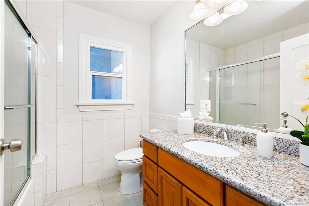 3605 East Del Mar Boulevard Pasadena, CA 91107 - Photo 20 of 22 a bathroom with a granite countertop sink and a mirror
