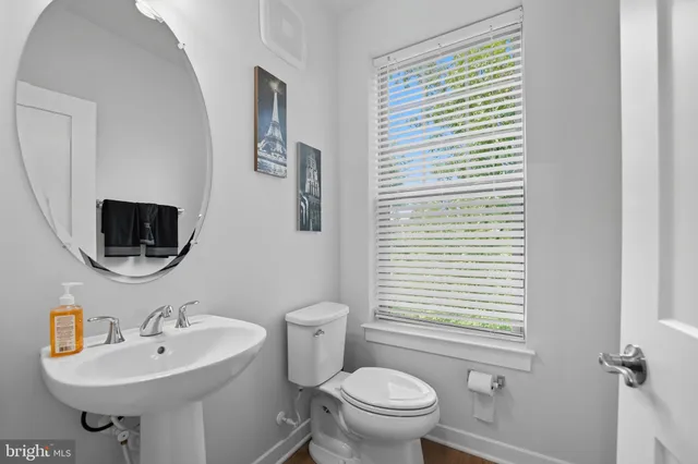 a bathroom with a sink toilet a mirror and tub