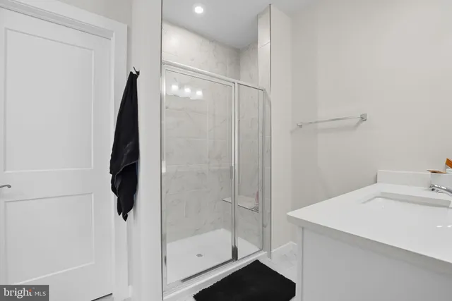 a bathroom with a shower and a sink