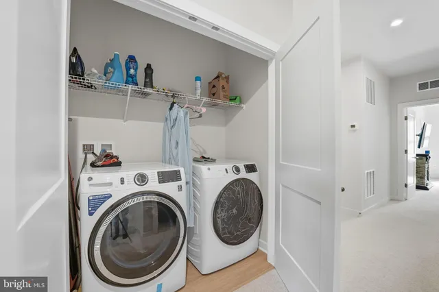 a view of storage and utility room with washer and dryer