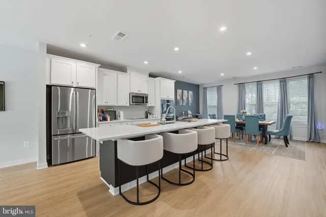 a large kitchen with a table and chairs