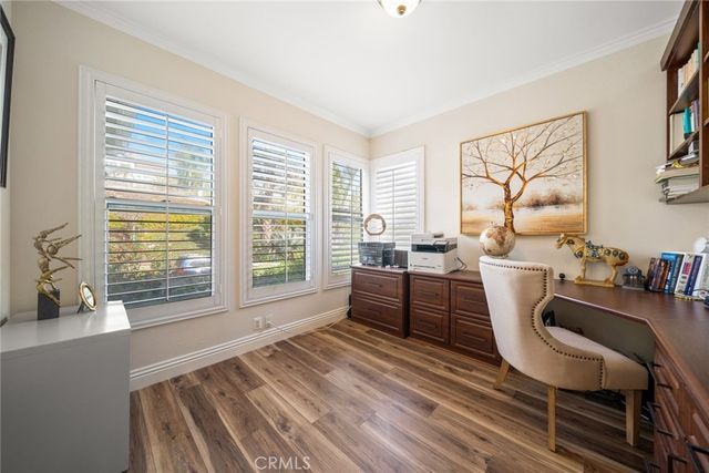 a dining room with wooden floor and furniture