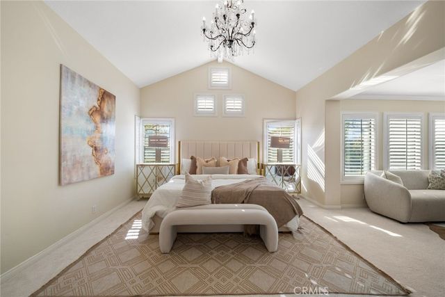 a bedroom with a bed couch and window
