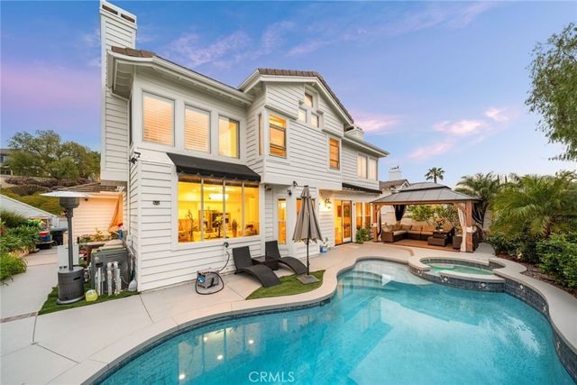 a view of a house with swimming pool and sitting area