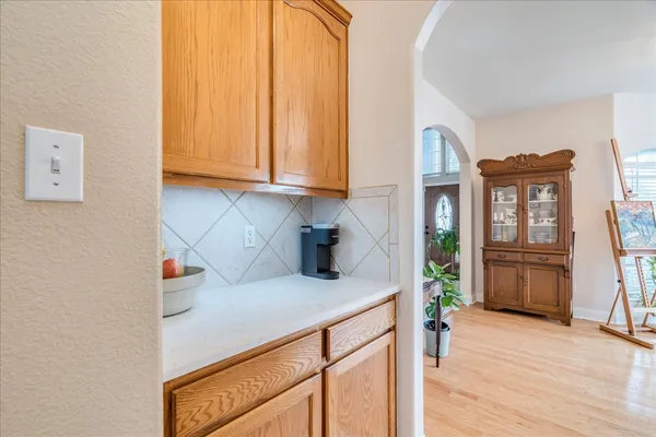 a large kitchen with a table and chairs
