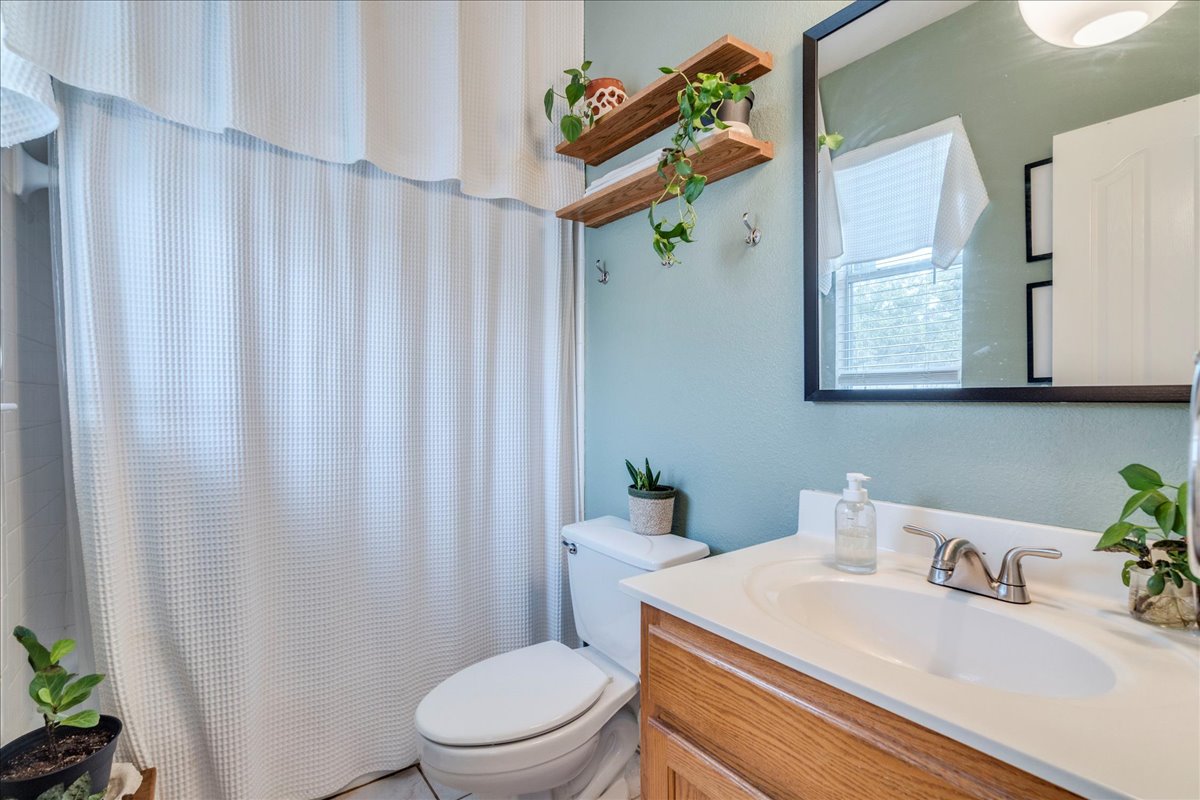 1077 Fairway Kyle, TX 78640 - Photo 21 of 40 a bathroom with a sink a toilet and a mirror