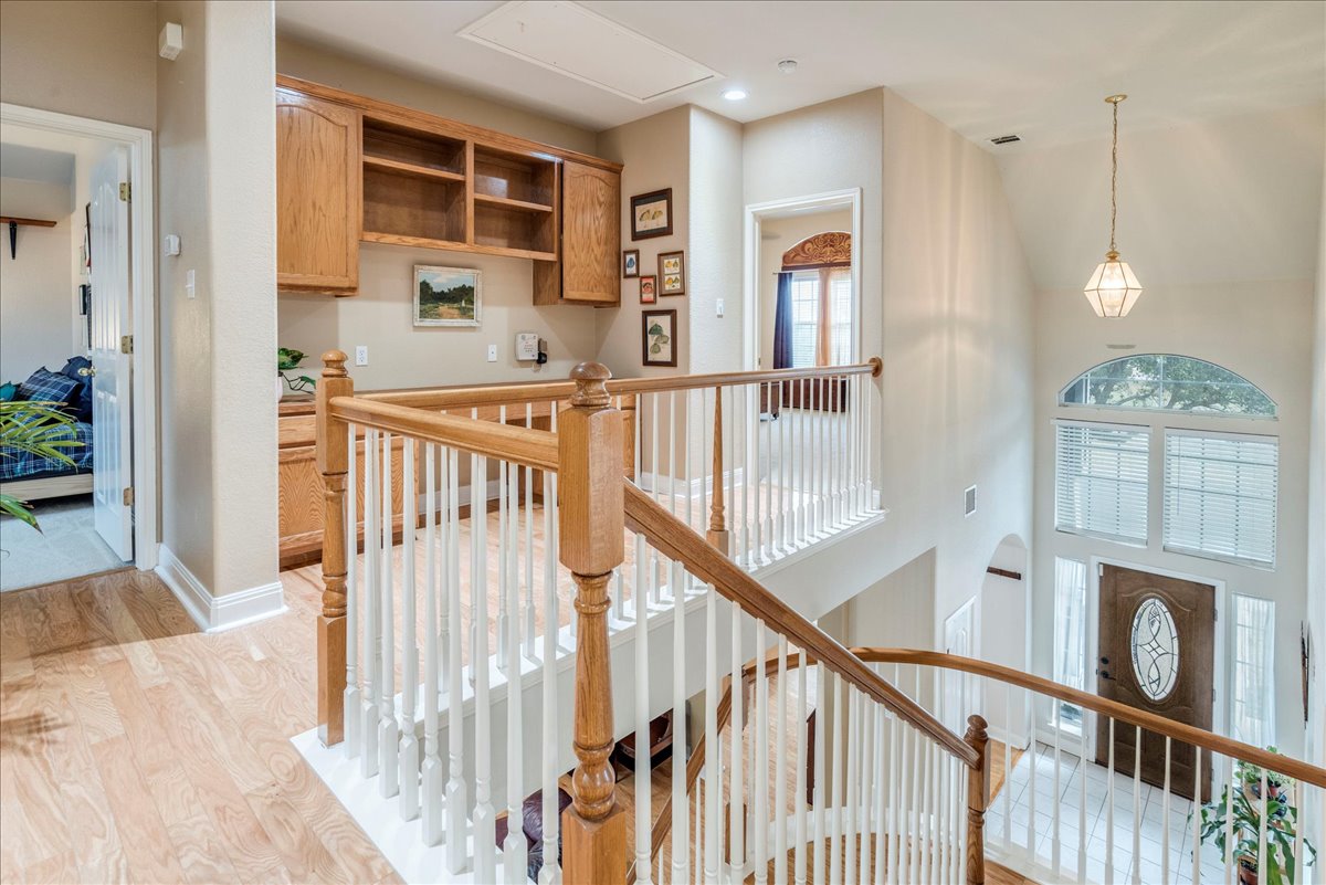 1077 Fairway Kyle, TX 78640 - Photo 22 of 40 a view of a hallway with wooden floor and windows