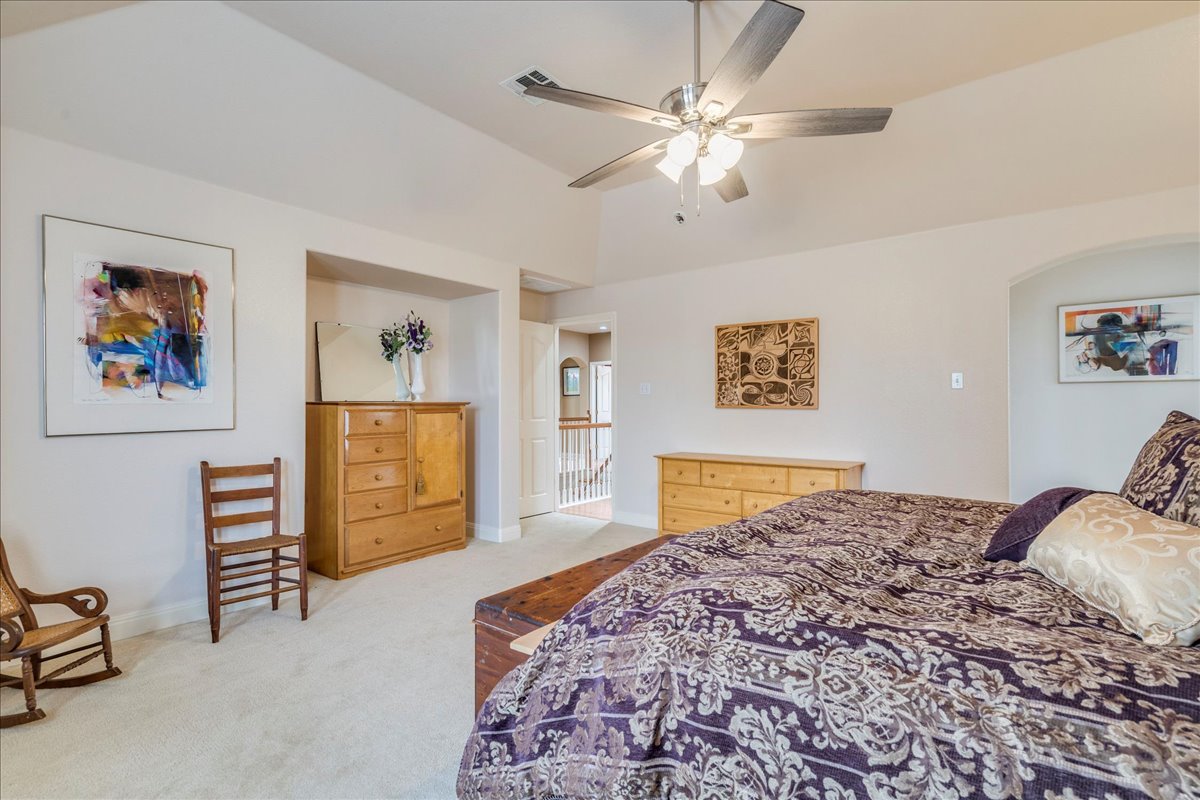 1077 Fairway Kyle, TX 78640 - Photo 25 of 40 a bedroom with a bed and a chandelier