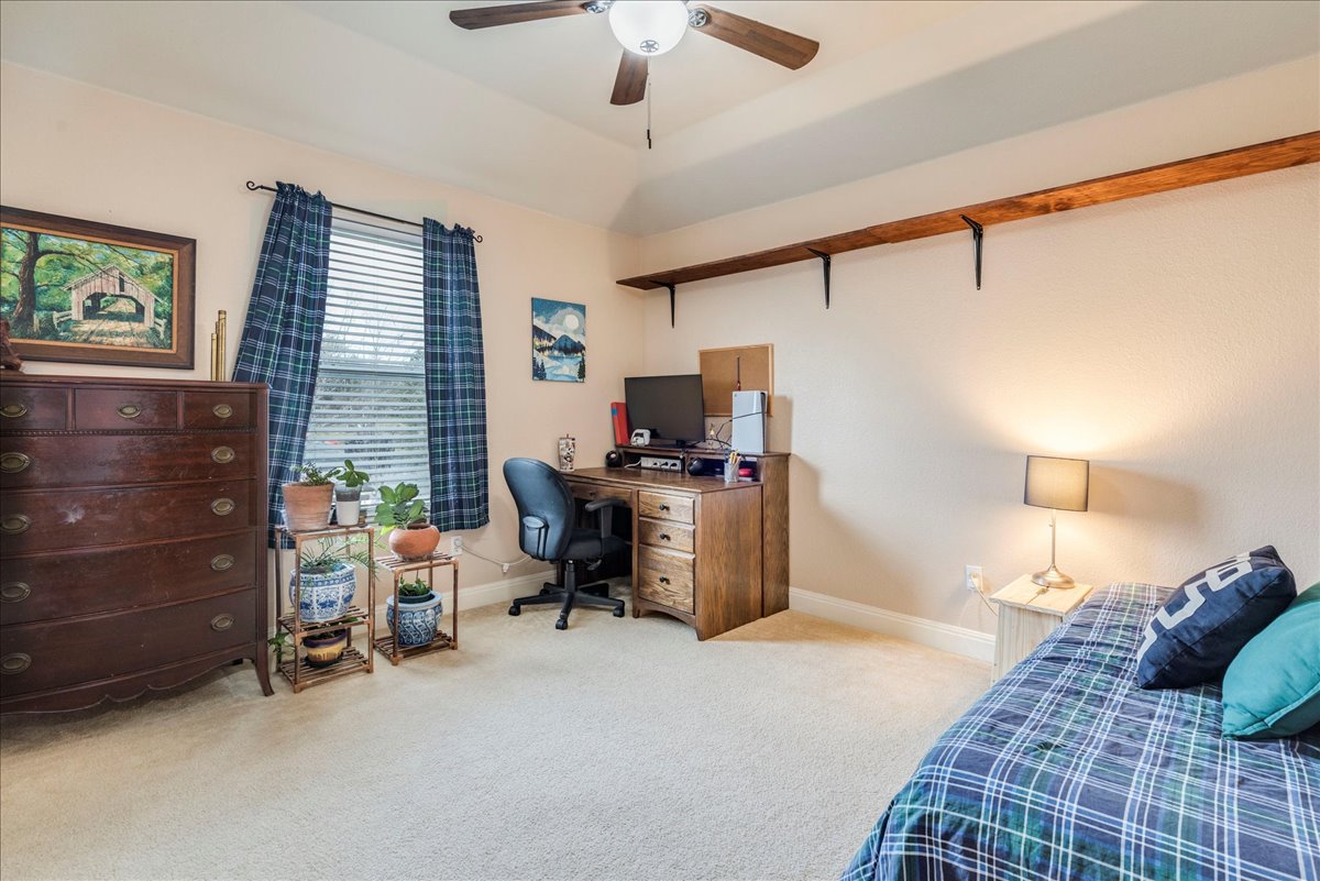 1077 Fairway Kyle, TX 78640 - Photo 29 of 40 a bedroom with a bed and a chandelier