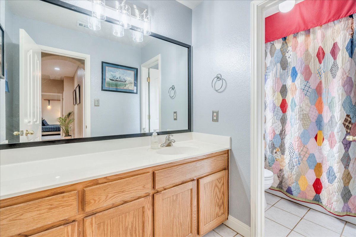 1077 Fairway Kyle, TX 78640 - Photo 35 of 40 a bathroom with a sink vanity and mirror