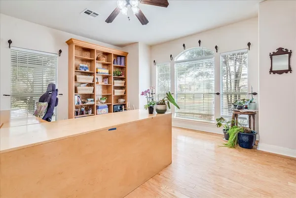 a living room with furniture and large windows