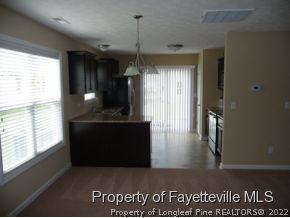 25 Loyalist Road Cameron, NC 28326 - Photo 8 of 12 a kitchen with granite countertop a refrigerator a stove and a window